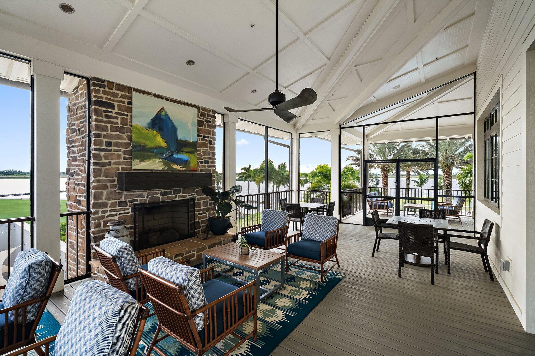 19540 Wheelbarrow Bend Loxahatchee, FL 33470 - Photo 44 of 54 a living room with furniture a fireplace and a floor to ceiling window