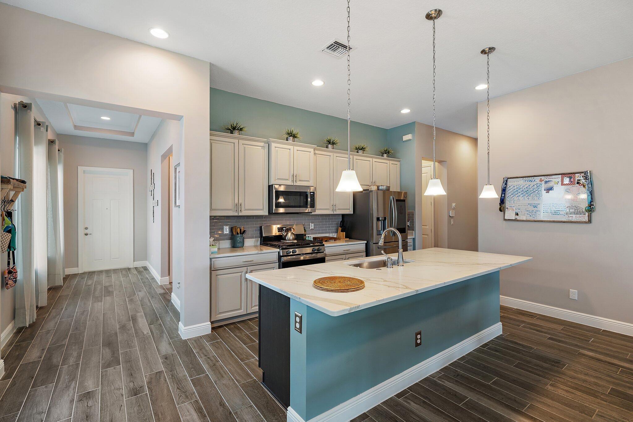 19540 Wheelbarrow Bend Loxahatchee, FL 33470 - Photo 8 of 54 a kitchen with a sink a stove and refrigerator