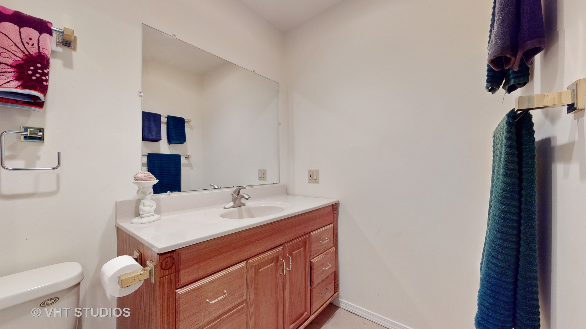 103 Crystal Lake Road Lake In The Hills, IL 60156 - Photo 31 of 42 a bathroom with a sink a toilet and a mirror