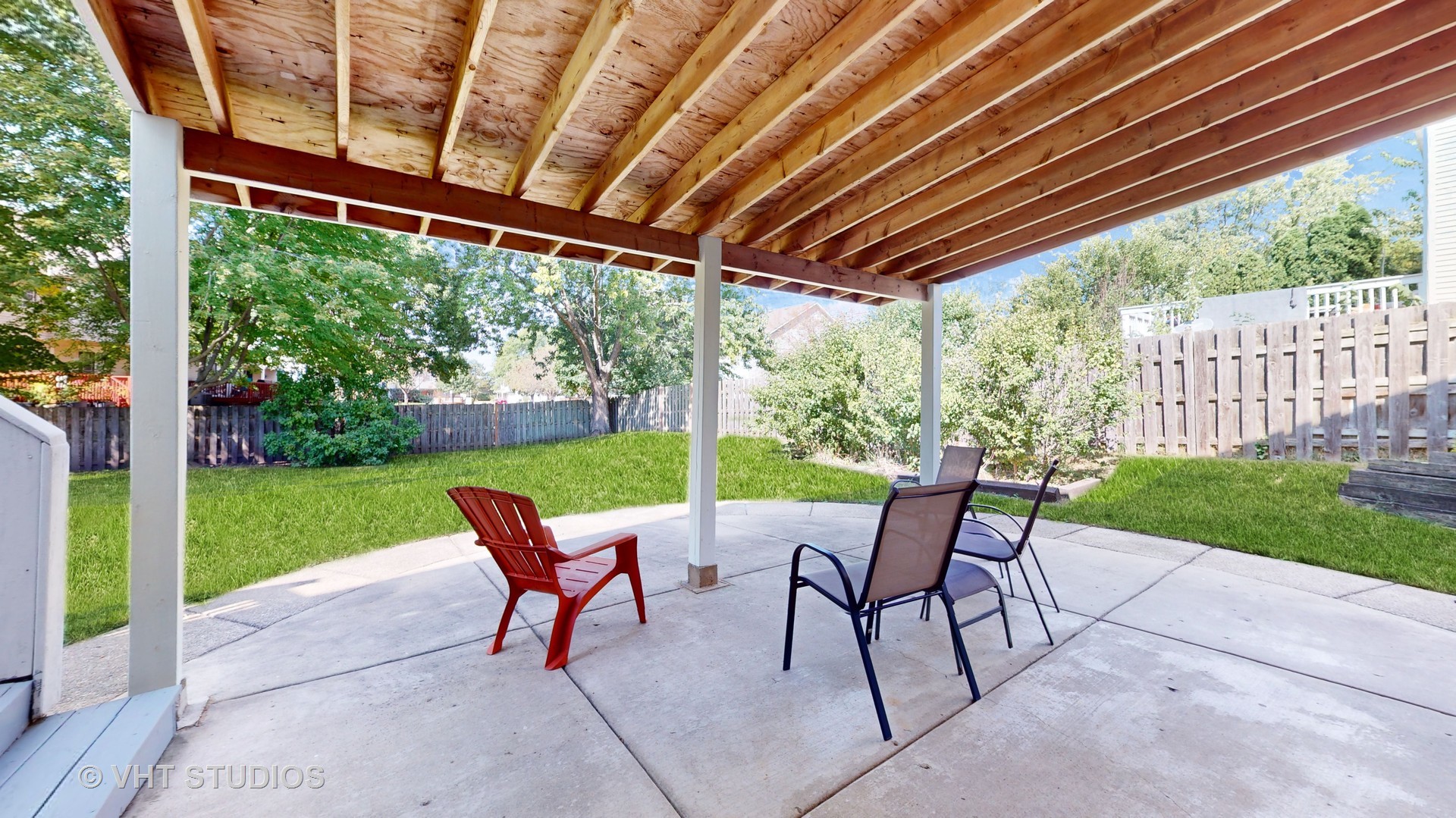 103 Crystal Lake Road Lake In The Hills, IL 60156 - Photo 35 of 42 a view of patio with table and chairs next to yard with wooden fence