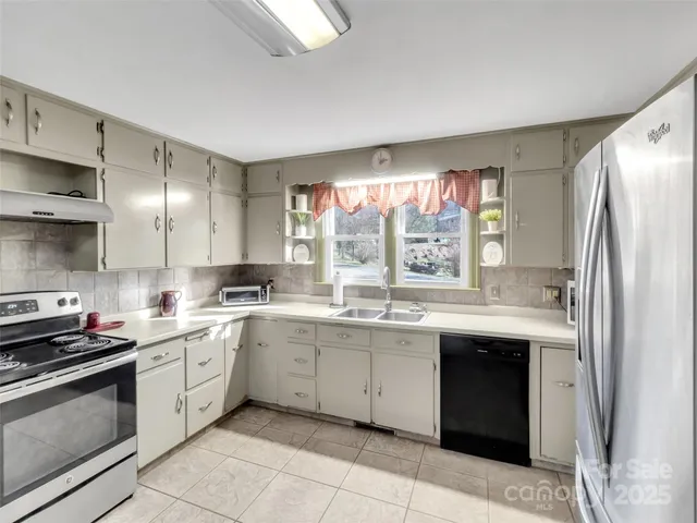 a kitchen with a sink stove and refrigerator