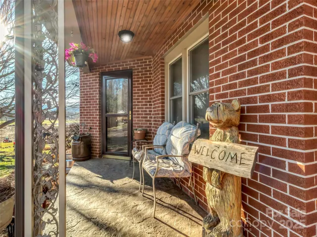 a view of a patio with table and chairs and potted plants