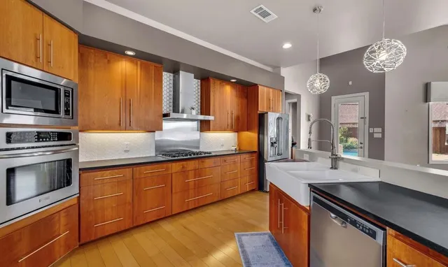 a kitchen with stainless steel appliances granite countertop a stove and a refrigerator