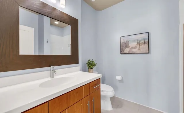 an empty room with potted plants and a window