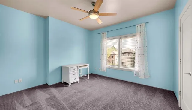 a view of a big room with wooden floor and windows