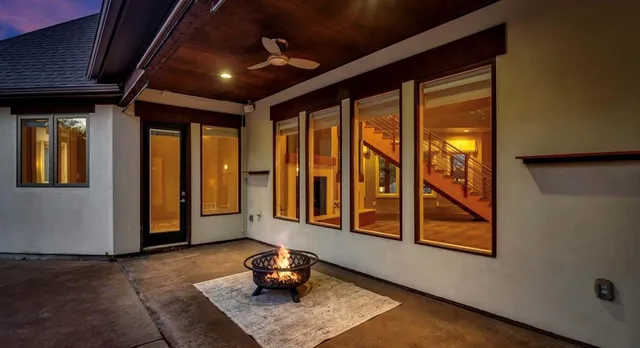 a view of a house with a yard fire pit and outdoor seating
