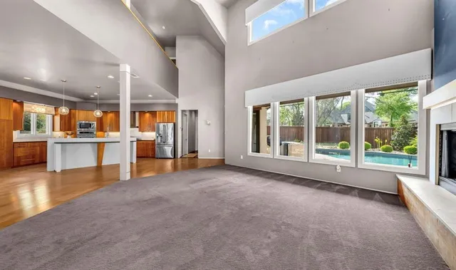 wooden floor and an empty room with a large window