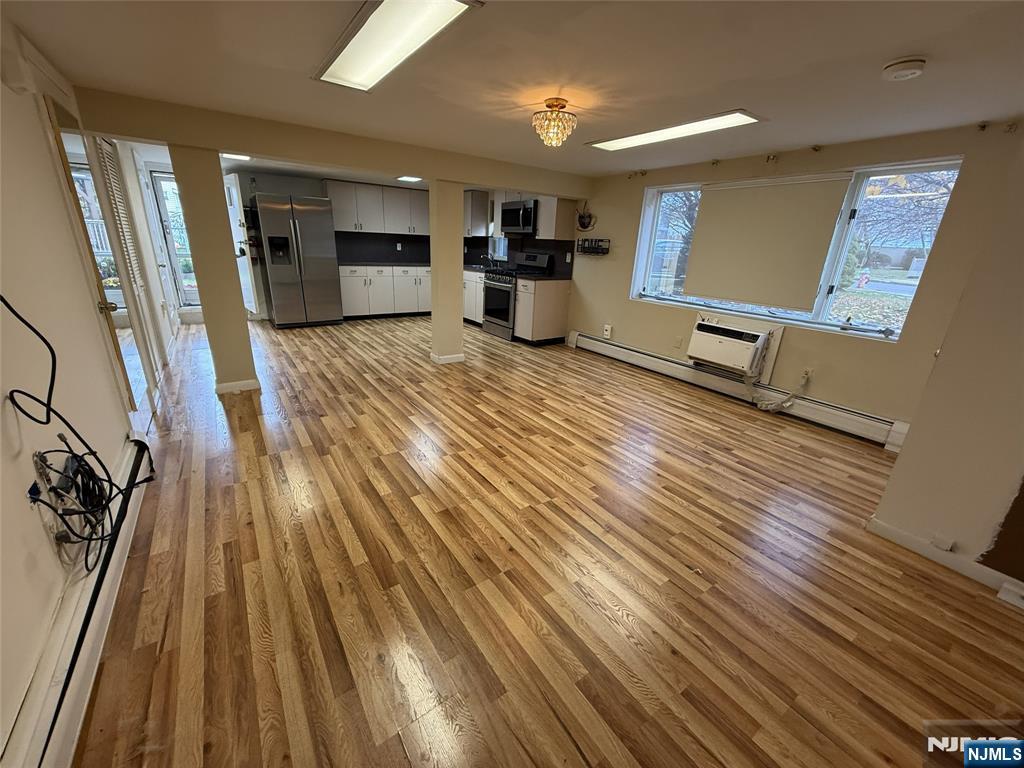 2 Millo Place, Unit 1 Little Ferry, NJ 07643 - Photo 3 of 8 a view of a living room with wooden floor