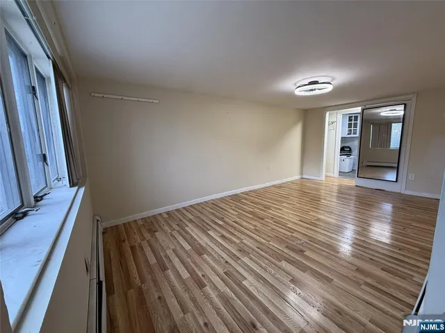 a view of a room with wooden floor and staircase