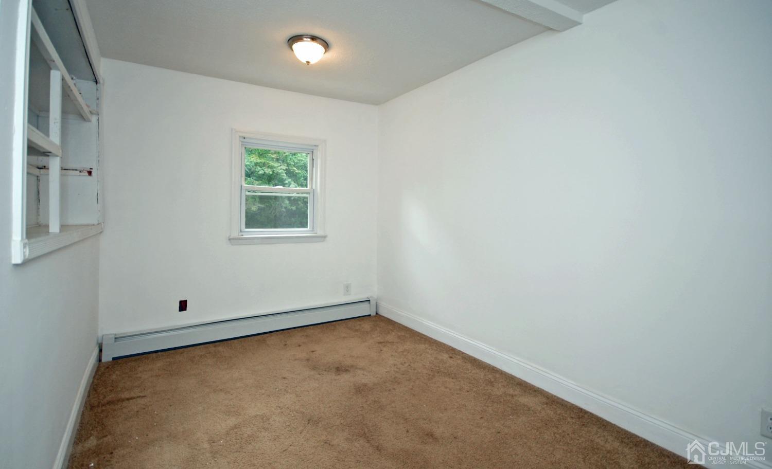 82 Red Valley Road Millstone Township, NJ 08510 - Photo 16 of 26 an empty room with a window