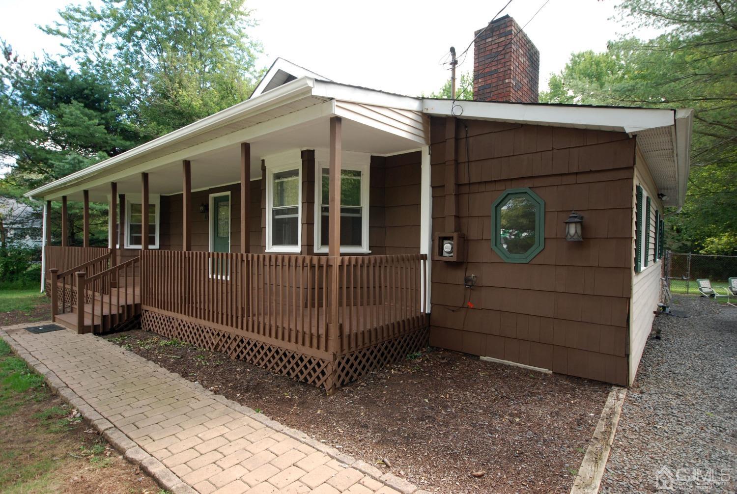 82 Red Valley Road Millstone Township, NJ 08510 - Photo 4 of 26 a front view of a house with a porch