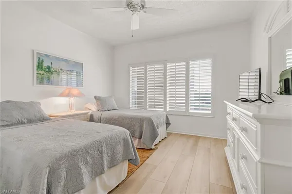 a spacious bedroom with two beds and a window