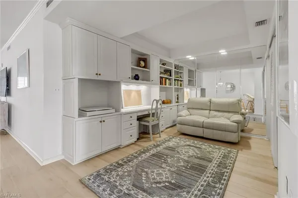 a living room with furniture appliances and a rug