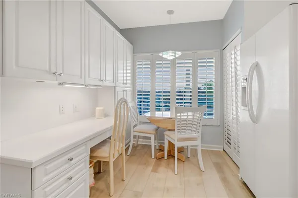 a view of a dining room with furniture and a window