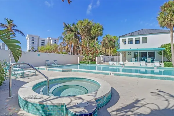 a swimming pool with outdoor seating and yard