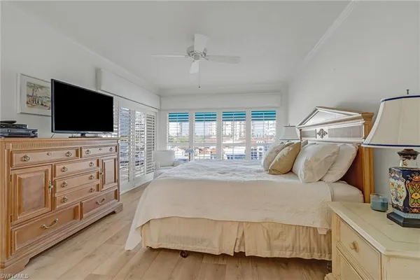 a bedroom with a bed and flat screen tv