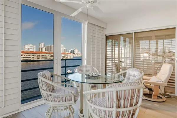 a dining room with furniture window and wooden floor