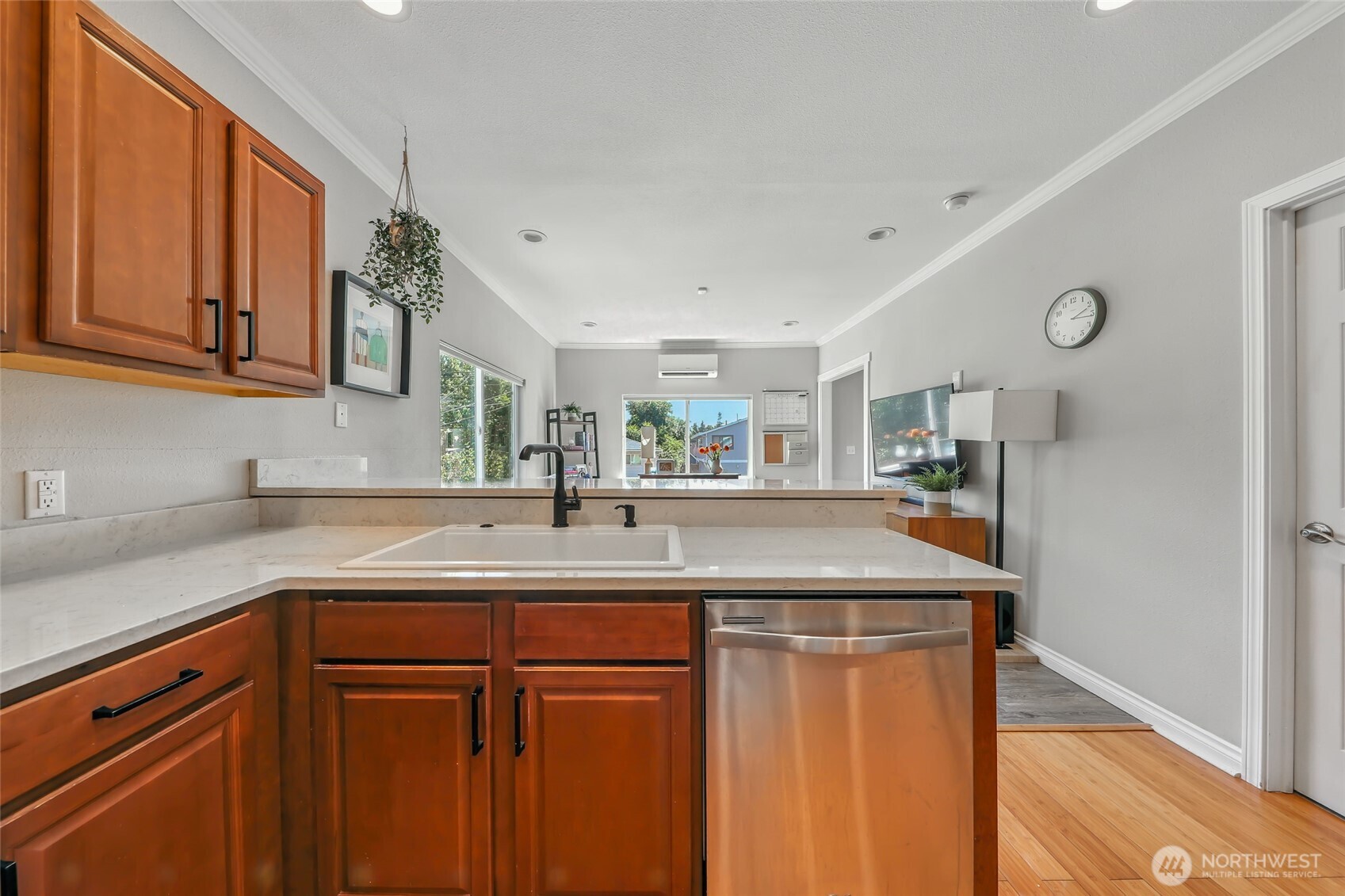 4616 South Orcas Street Seattle, WA 98118 - Photo 13 of 37 a kitchen with stainless steel appliances granite countertop a sink and dishwasher with wooden cabinets