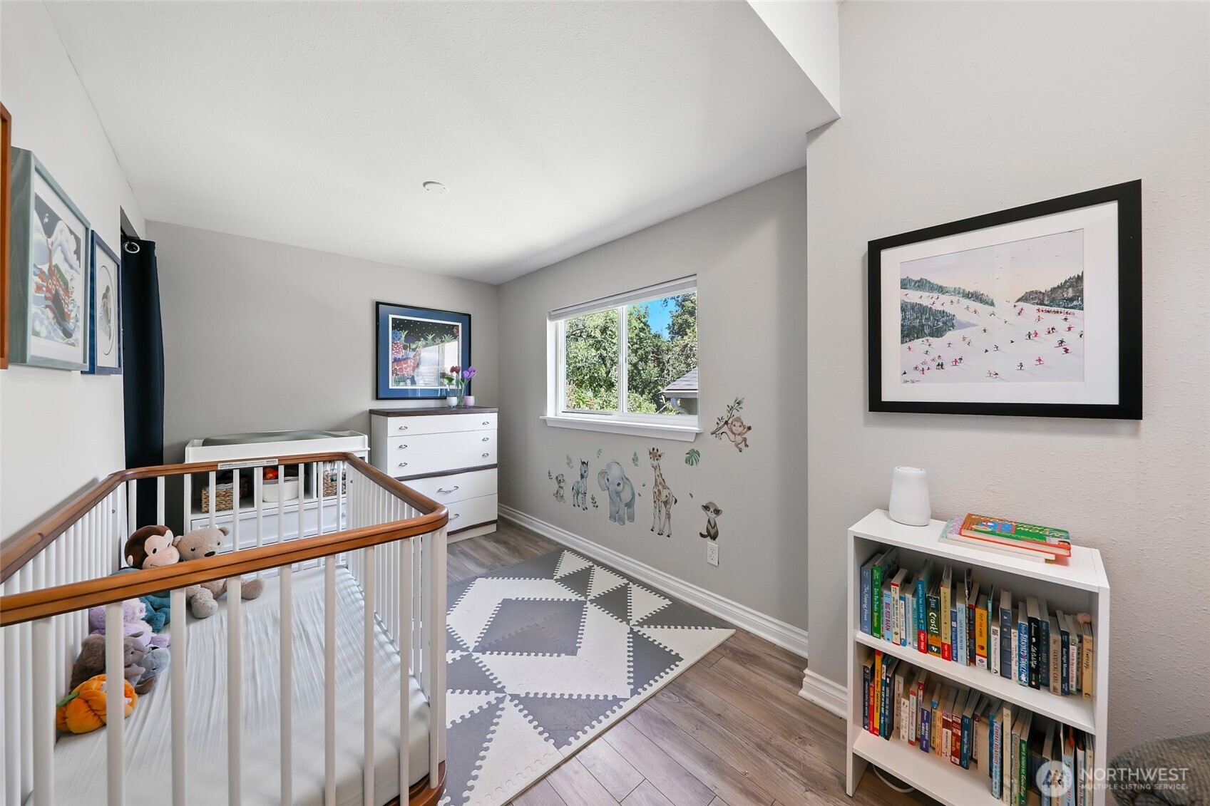 4616 South Orcas Street Seattle, WA 98118 - Photo 16 of 37 a bedroom with furniture and a book shelf