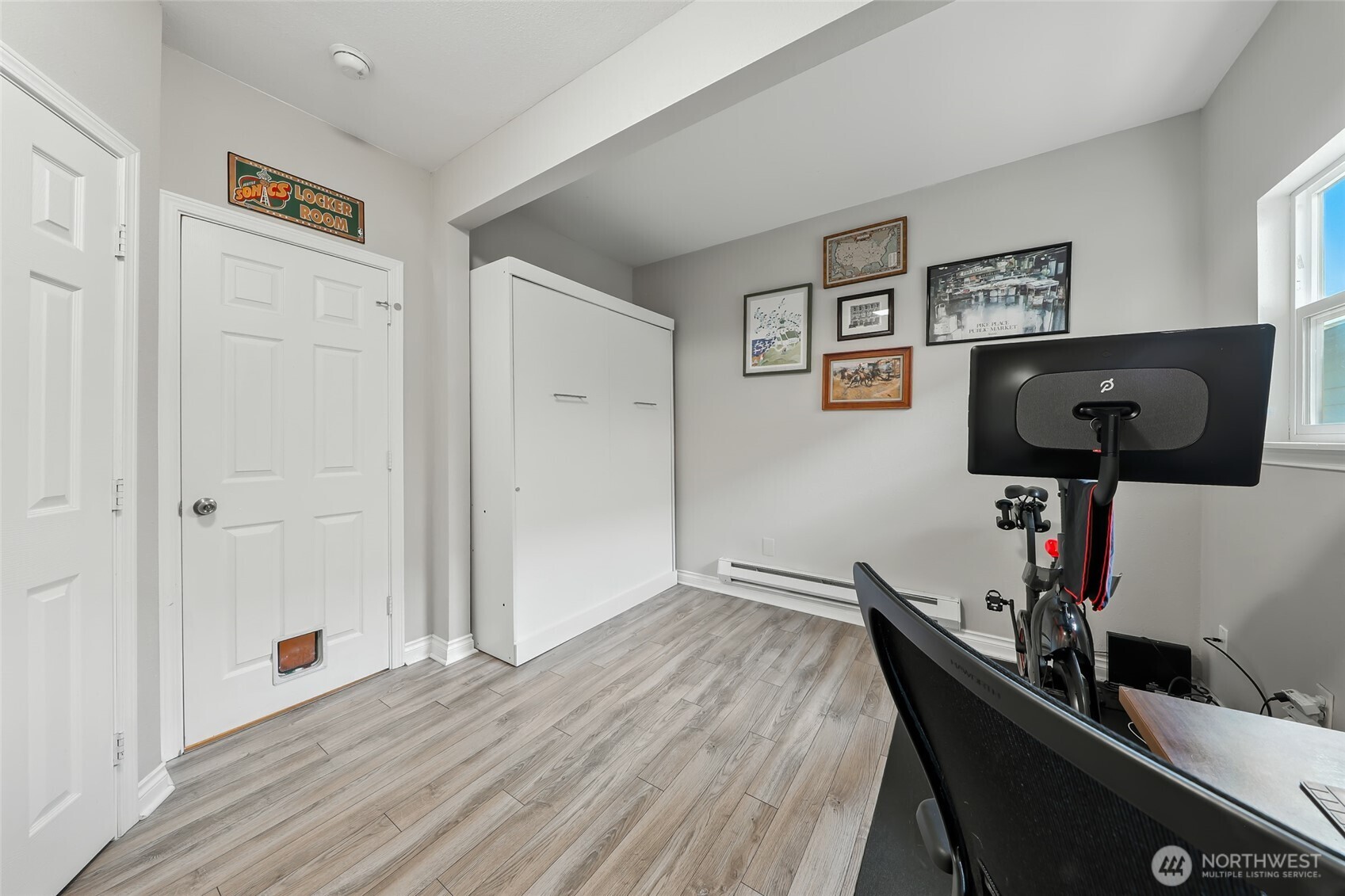 4616 South Orcas Street Seattle, WA 98118 - Photo 20 of 37 a view of a workspace with furniture and wooden floor