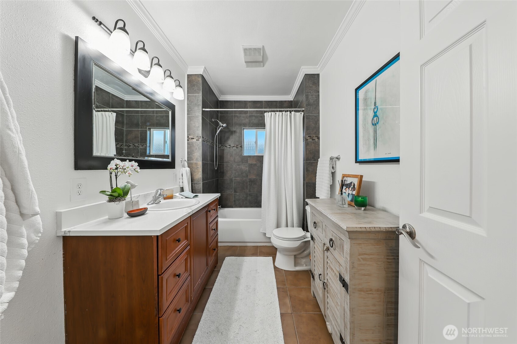 4616 South Orcas Street Seattle, WA 98118 - Photo 23 of 37 a bathroom with a sink mirror vanity and toilet