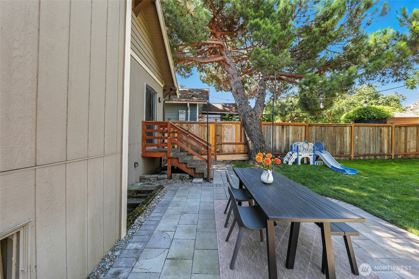4616 South Orcas Street Seattle, WA 98118 - Photo 27 of 37 a backyard of a house with barbeque oven table and chairs