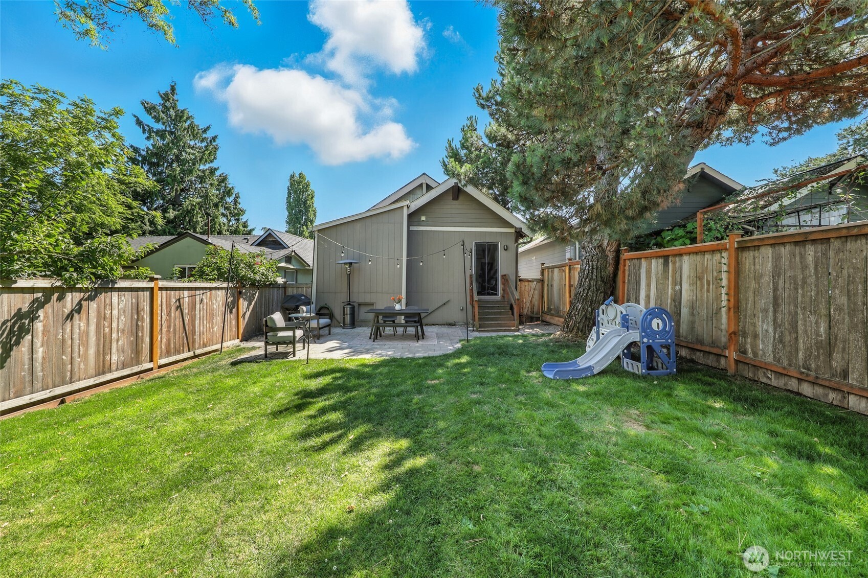 4616 South Orcas Street Seattle, WA 98118 - Photo 30 of 37 a view of a backyard with a sitting area and slide