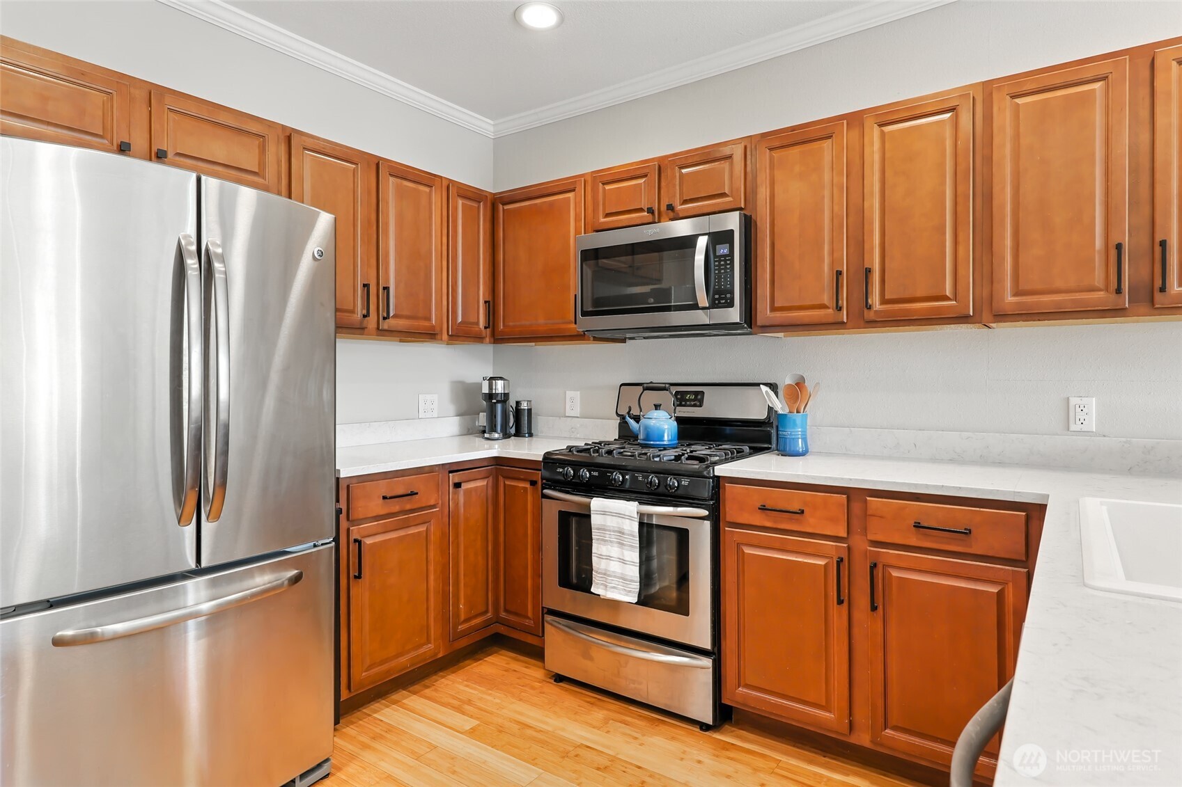 4616 South Orcas Street Seattle, WA 98118 - Photo 9 of 37 a kitchen with stainless steel appliances granite countertop a refrigerator stove top oven and sink