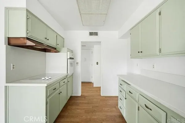 a kitchen with granite countertop a sink and cabinets