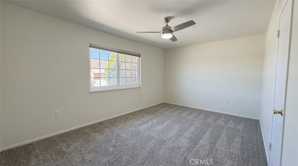 27077 El Rancho Drive Menifee, CA 92586 - Photo 5 of 11 an empty room with windows and fan