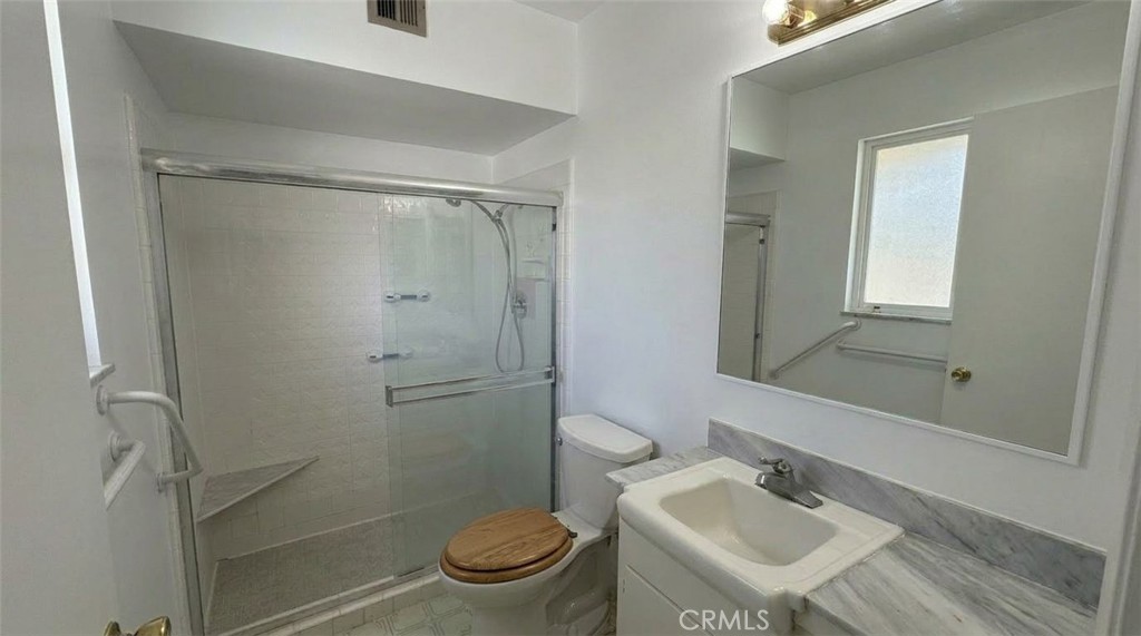 27077 El Rancho Drive Menifee, CA 92586 - Photo 8 of 11 a bathroom with a sink toilet and shower
