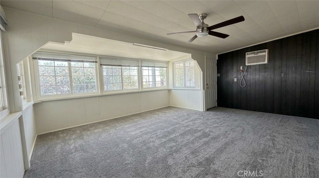 27077 El Rancho Drive Menifee, CA 92586 - Photo 9 of 11 an empty room with chandelier fan and windows