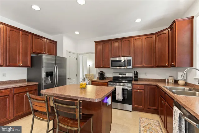 a kitchen with a stove a sink a microwave and refrigerator