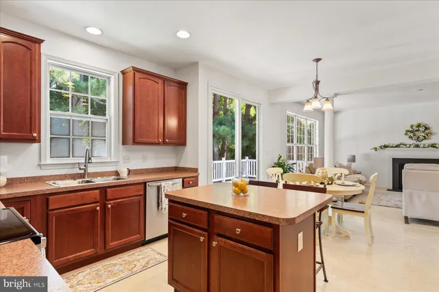 a kitchen with a sink and living room