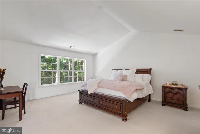 a bed and a night stand sitting in a bedroom