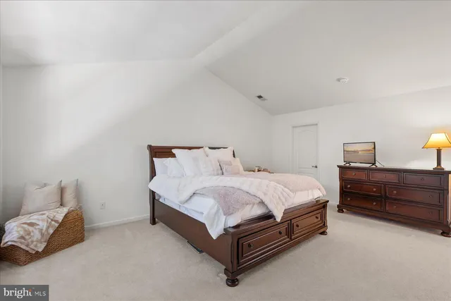a spacious bathroom with a double vanity sink large mirror and a bathtub