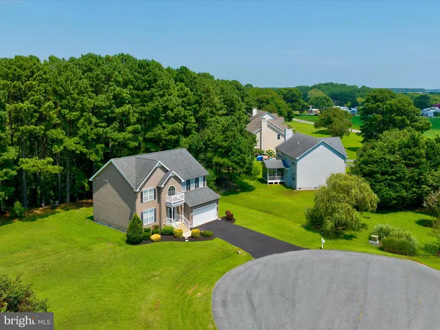 a aerial view of a house with yard and a garden