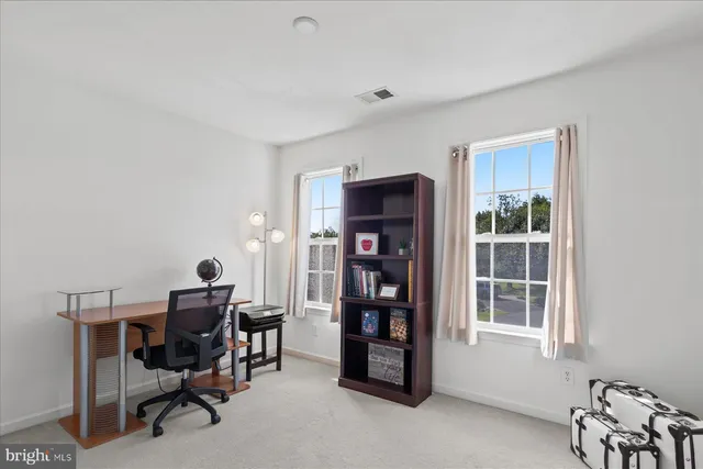 a room with bookshelf and a window