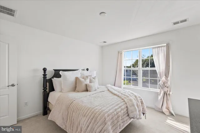 a bedroom with bed and a window