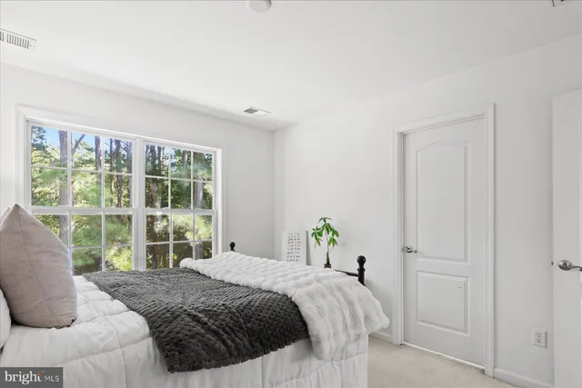 a bedroom with a bed and hallway