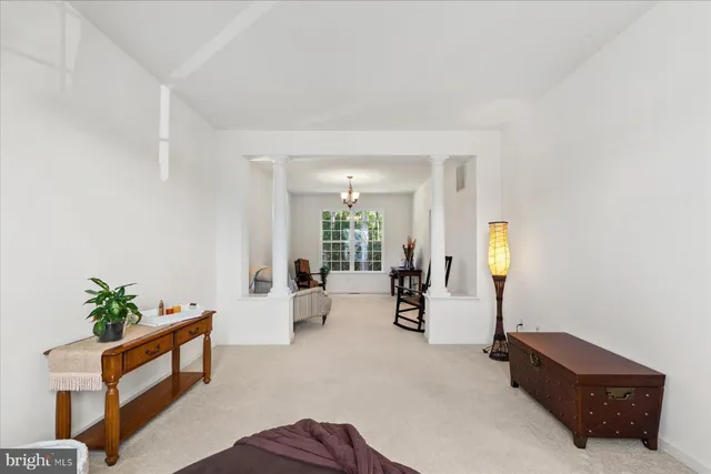 a living room with furniture and potted plant