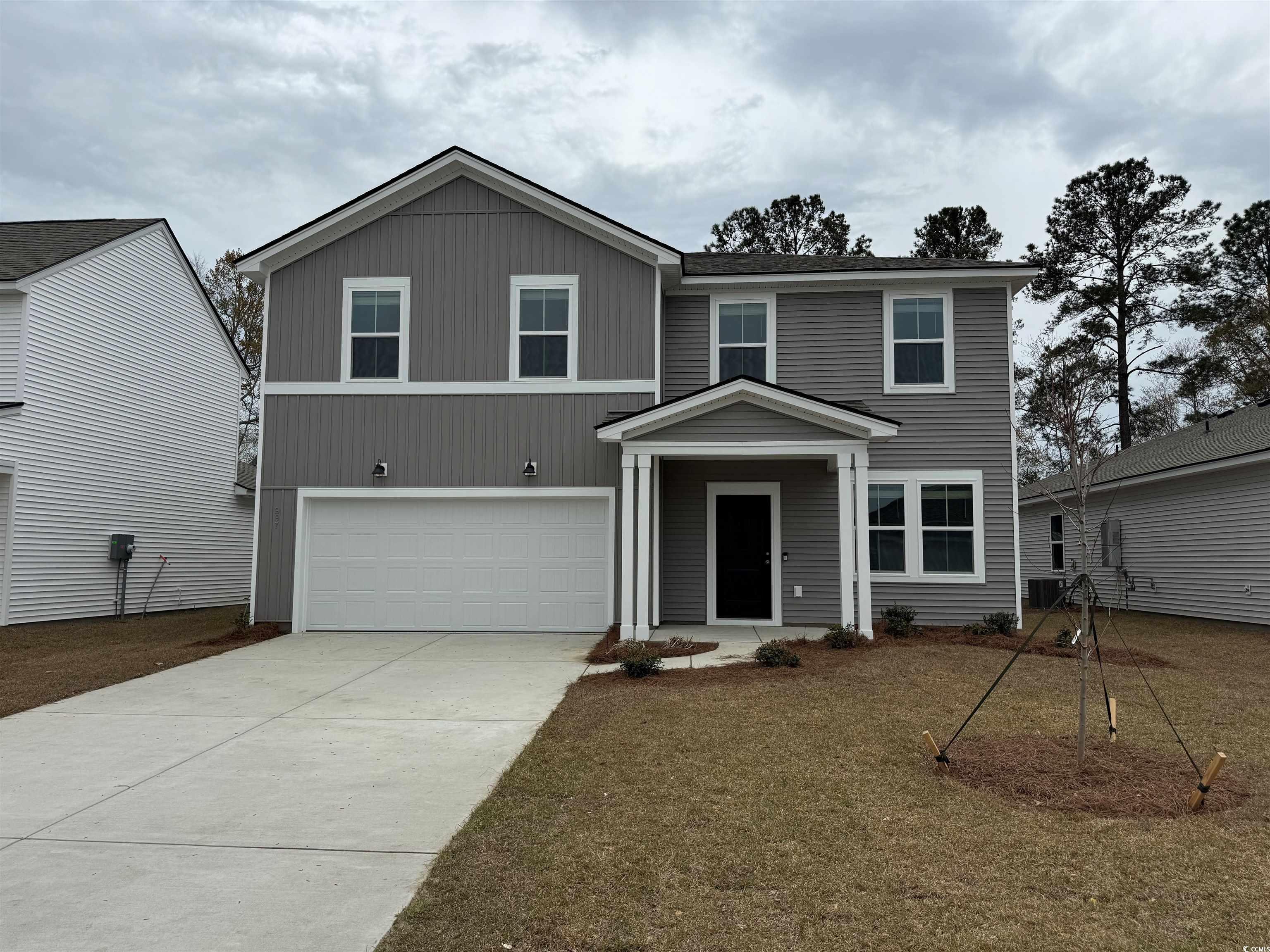 Traditional home with a garage and concrete drivew