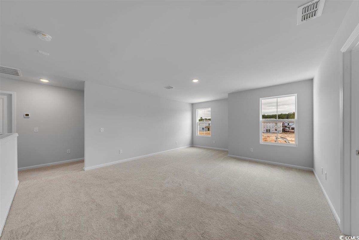 997 Laconic Drive Myrtle Beach, SC 29588 - Photo 11 of 22 Empty room featuring light carpet, baseboards, and