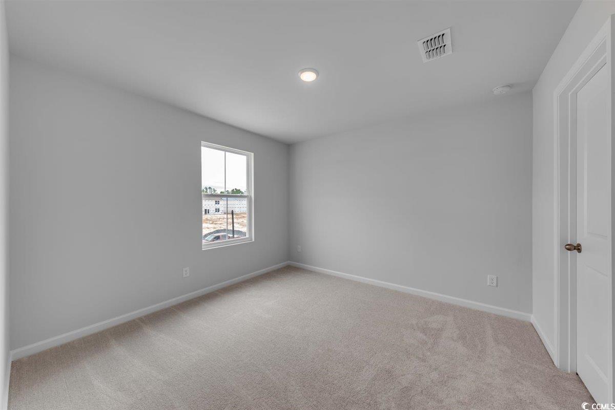 997 Laconic Drive Myrtle Beach, SC 29588 - Photo 15 of 22 Carpeted empty room with baseboards and visible ve