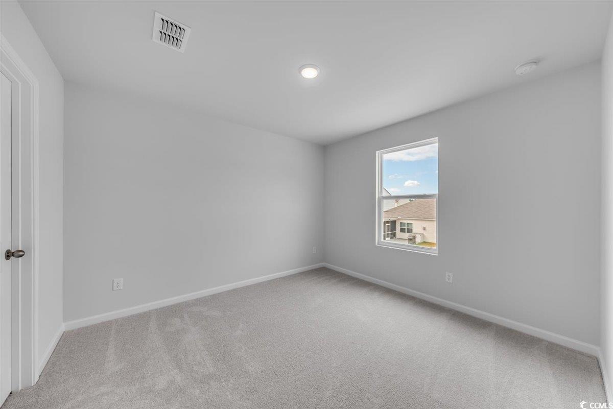 997 Laconic Drive Myrtle Beach, SC 29588 - Photo 17 of 22 Carpeted empty room featuring baseboards and visib