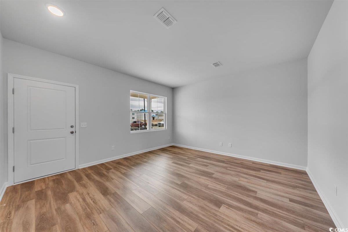 997 Laconic Drive Myrtle Beach, SC 29588 - Photo 4 of 22 Unfurnished room featuring light wood-style floori