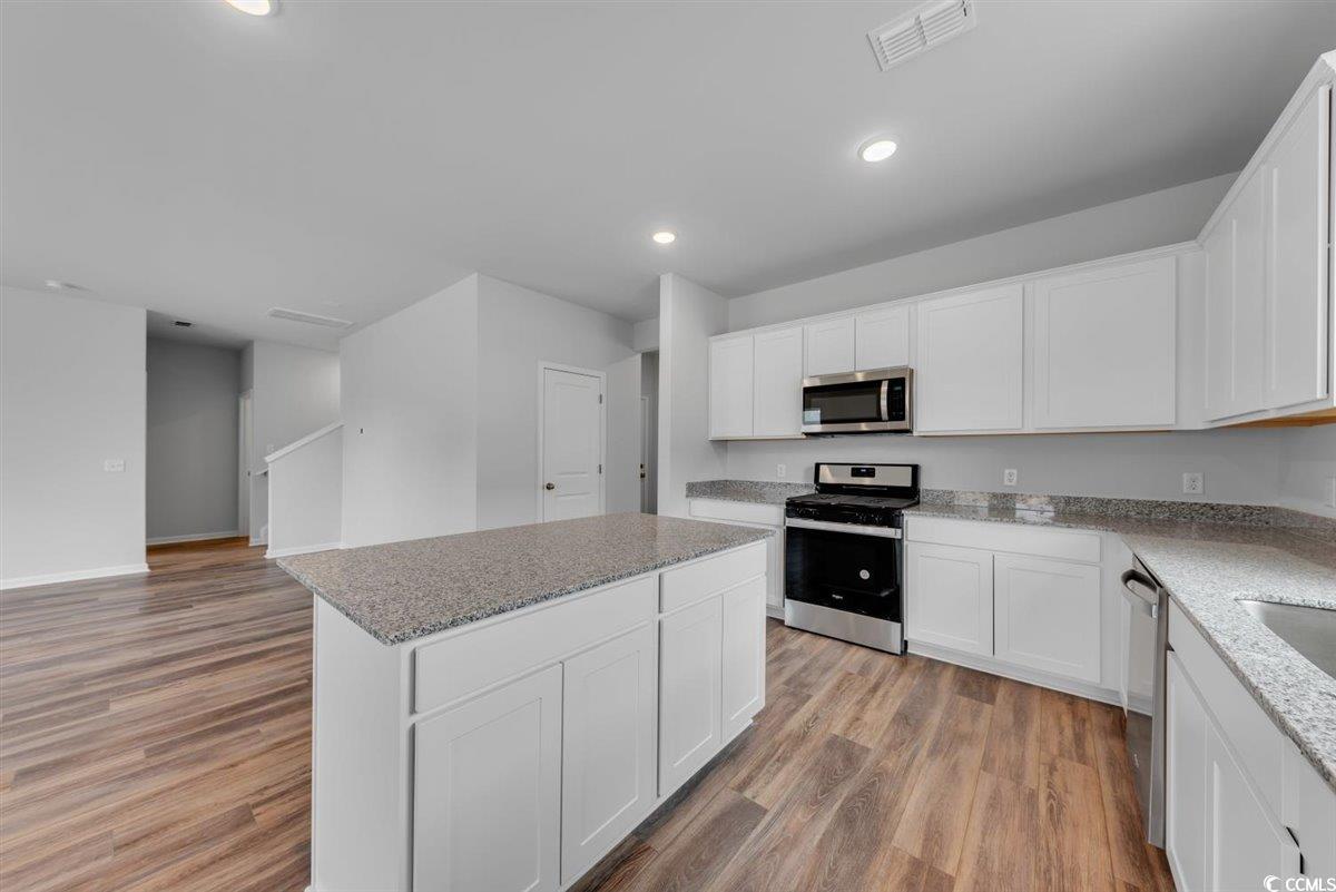 997 Laconic Drive Myrtle Beach, SC 29588 - Photo 9 of 22 Kitchen with light wood-type flooring, a center is