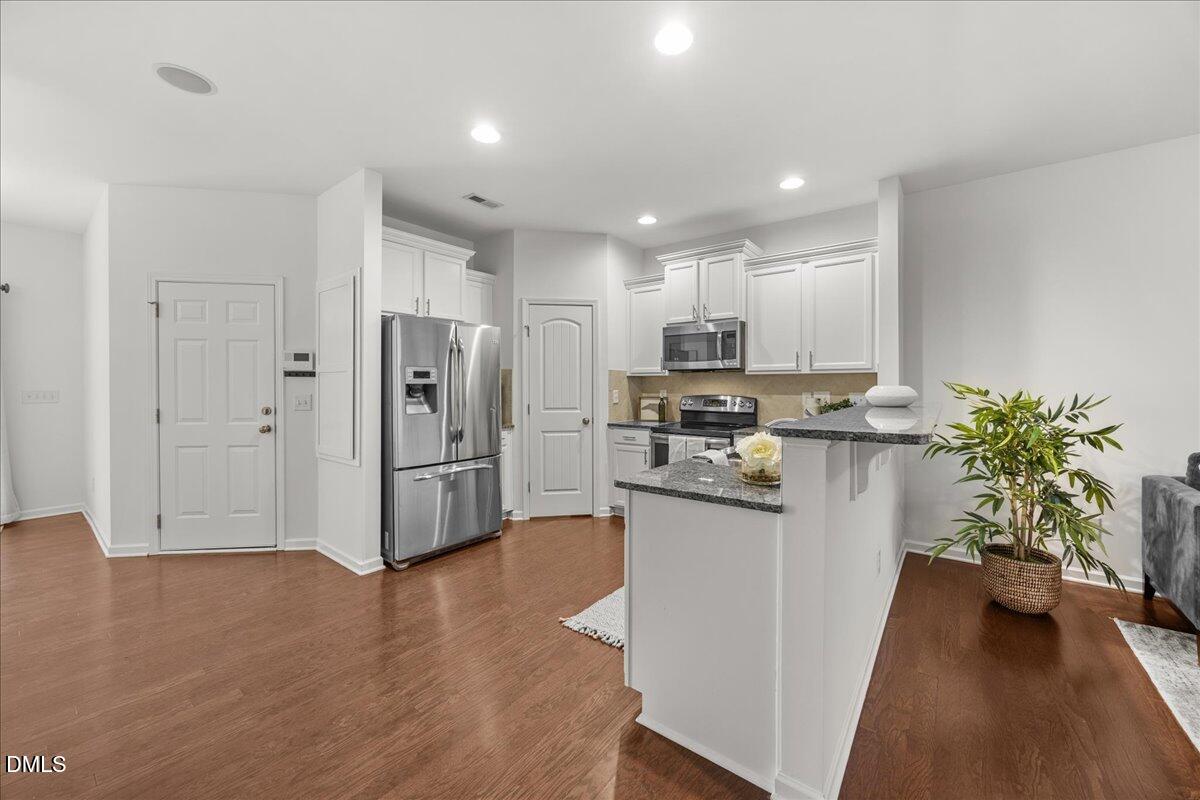 1003 Ileagnes Road Raleigh, NC 27603 - Photo 12 of 42 a kitchen with stainless steel appliances a refrigerator and a stove top oven