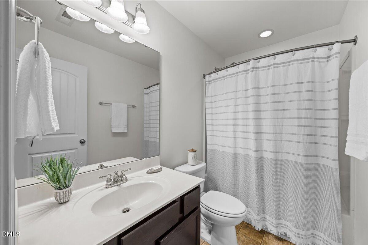 1003 Ileagnes Road Raleigh, NC 27603 - Photo 25 of 42 a bathroom with a sink toilet and shower