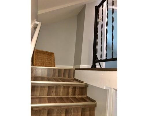 155 Methuen Street Springfield, MA 01119 - Photo 11 of 24 a view of staircase with white walls and a window